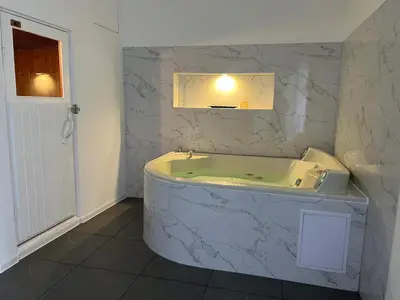a bathroom with a bath tub and a sink at Residence Deluxe Ljubijankici in Ljubijankići
