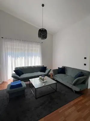 a living room with a couch and a table at Residence Deluxe Ljubijankici in Ljubijankići