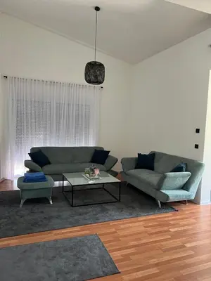 a living room with a couch and a table at Residence Deluxe Ljubijankici in Ljubijankići