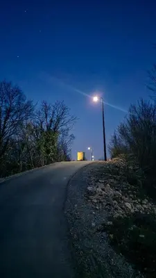 a street light on the side of a road at night at Apartman NAFO in Bihać