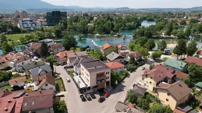 an aerial view of a town with a river at Milky Way in Bihać