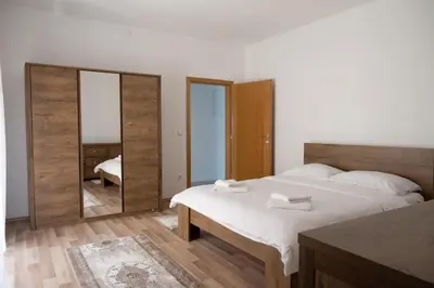 a bedroom with a large bed and a mirror at Milky Way in Bihać