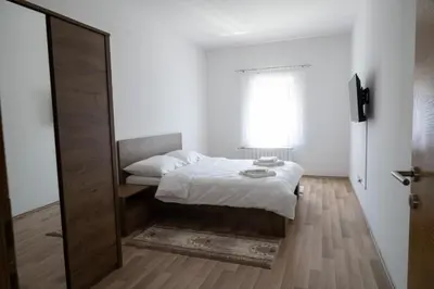 a small bedroom with a bed and a window at Milky Way in Bihać