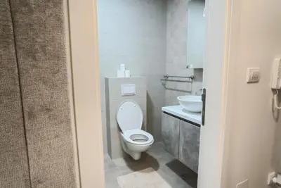 a bathroom with a toilet and a sink at Hedonist Garden Luxury Apartments in Doboj