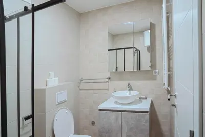 a bathroom with a sink and a toilet and a mirror at Hedonist Garden Luxury Apartments in Doboj