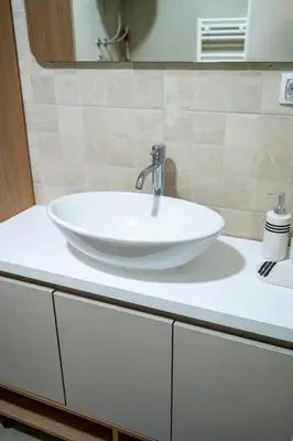 a white sink on a counter in a bathroom at Hedonist Garden Luxury Apartments in Doboj
