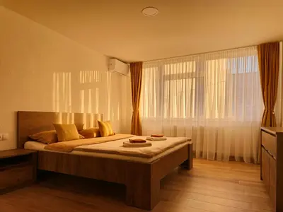 a bedroom with a bed and a large window at Apartman Trg 892 in Livno