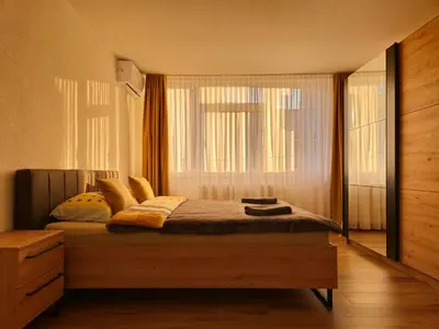a bedroom with a large bed with a window at Apartman Trg 892 in Livno