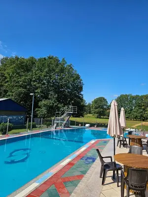 a swimming pool with tables and chairs and a slide at Camping Stevin ranc in Bosanska Dubica