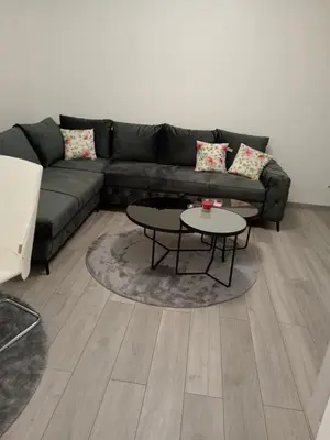 a living room with a couch and a table at Sokak Apartman in Bihać