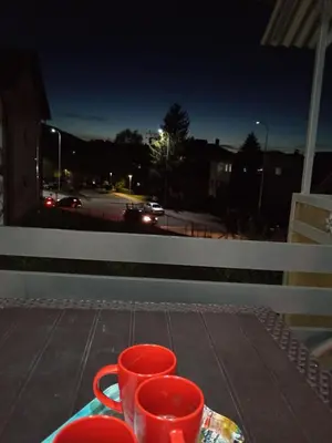 two cups on a table with a view of a street at Sokak Apartman in Bihać