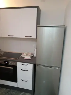 a kitchen with a stainless steel refrigerator and a stove at Sokak Apartman in Bihać