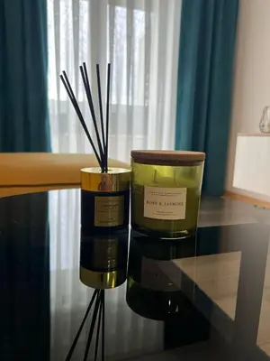 two candles are sitting on a glass table at Max stan na dan Doboj in Doboj