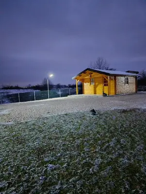 a yellow building on the side of a field at Vikendica Ajlin in Spahići