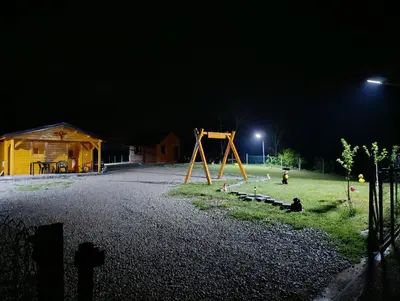 a park at night with a swing set and a playground at Vikendica Ajlin in Spahići