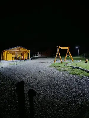 a night scene of a building and a playground at Vikendica Ajlin in Bihać