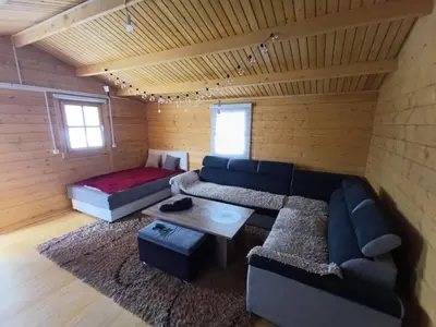 a living room with a couch and a table at Vikendica Ajlin in Bihać