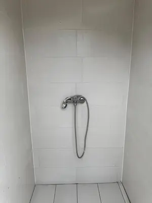 a shower with a silver shower head in a bathroom at Dream House Šeha in Bihać