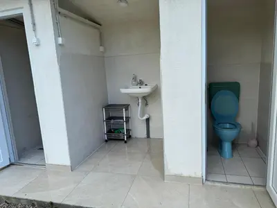 a bathroom with a blue toilet and a sink at Dream House Šeha in Bihać