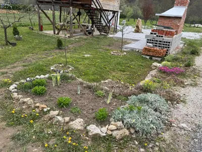a garden with flowers and plants in a yard at Dream House Šeha in Bihać