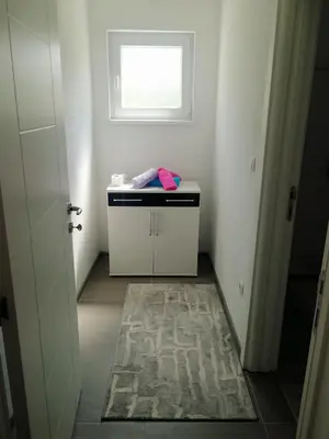 a small bathroom with a sink and a window at Apartman Oaza mira-Visoko in Visoko