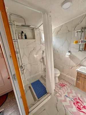 a bathroom with a shower and a toilet at Apartman Oaza mira-Visoko in Visoko