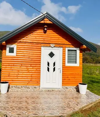 a small orange house with a white door at Apartman Oaza mira-Visoko in Visoko