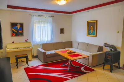 a living room with a couch and a table and a piano at Apartman MIŠKO in Bihać