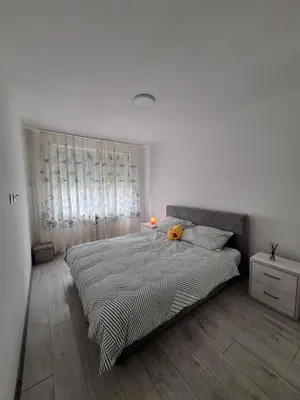 a white bedroom with a large bed and a window at Cosy Corner Doboj in Doboj