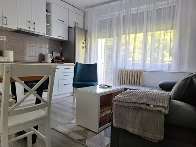 a kitchen and living room with a couch and a table at Cosy Corner Doboj in Doboj