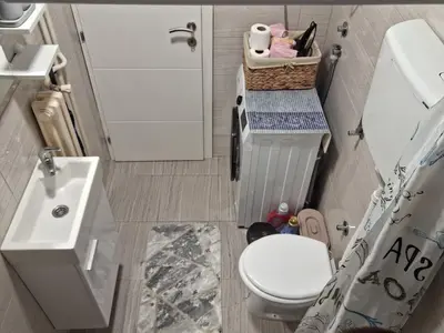 a small bathroom with a toilet and a sink at Cosy Corner Doboj in Doboj