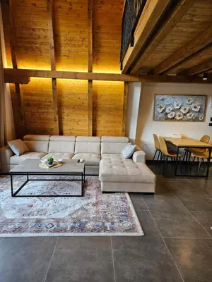 a living room with a couch and a table at Luxury Villa Mašić - 2 in Bugojno