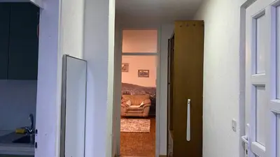 a hallway leading to a living room with a couch at Apartment 3A Visoko in Visoko