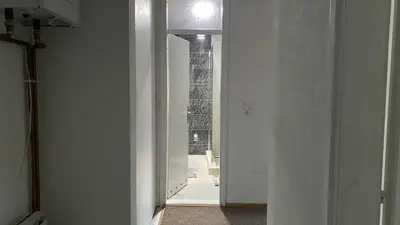 a hallway with a door to a room with a window at Apartment 3A Visoko in Visoko