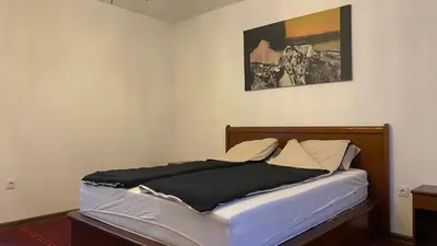 a bed in a room with a picture on the wall at Apartment 3A Visoko in Visoko