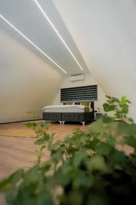 a room with a bed in a attic at Unea House in Bihać