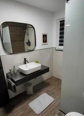a bathroom with a sink and a mirror at Unea House in Bihać