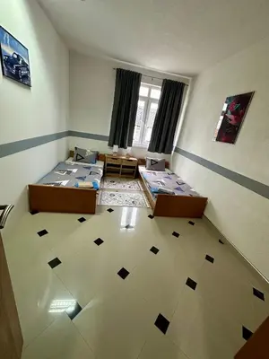 a room with two beds in a room with a floor at Apartmani Orhideja za 4 osobe in Sanski most