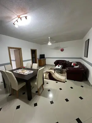 a living room with a table and a couch at Apartmani Orhideja za 4 osobe in Sanski most