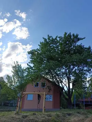 a house with a tree in front of it at Oaza mira Šipovo in Šipovo