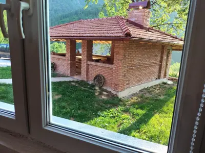 a view of a brick house from a window at Oaza mira Šipovo in Šipovo