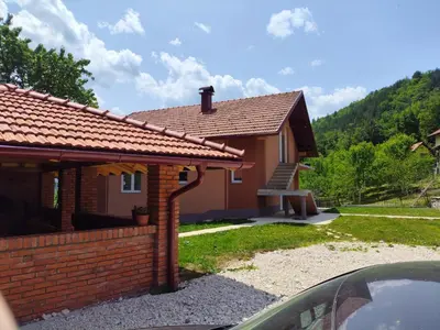 a small house with a brick wall at Oaza mira Šipovo in Šipovo