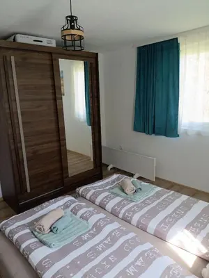 a bedroom with two beds and a large mirror at Oaza mira Šipovo in Šipovo