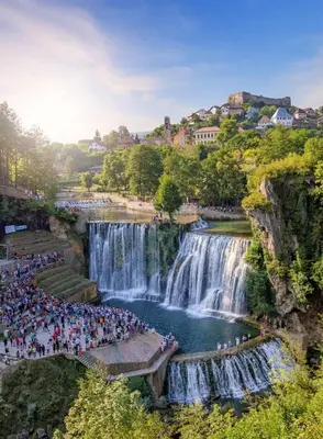 a crowd of people standing in front of a waterfall at Apartmani D&D 4 in Jajce