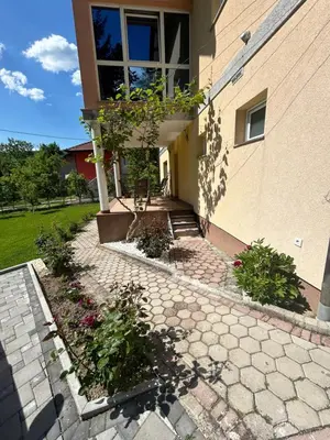 a building with a brick walkway in front of a building at Apartmani D&D 4 in Jajce