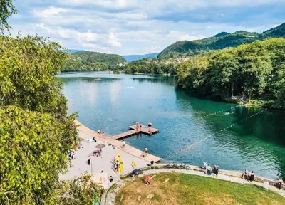 a view of a river with people on a bridge at Apartmani D&D 4 in Jajce