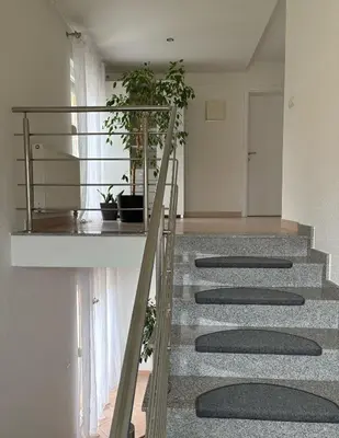 a group of stairs with potted plants on them at Apartmani D&D 4 in Jajce