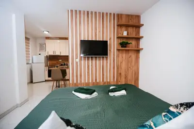 a bedroom with a bed with two towels on it at Apartment Vukeljic in Doboj