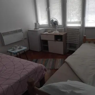 a bedroom with two beds and a mirror and windows at AM Rooms in Visoko