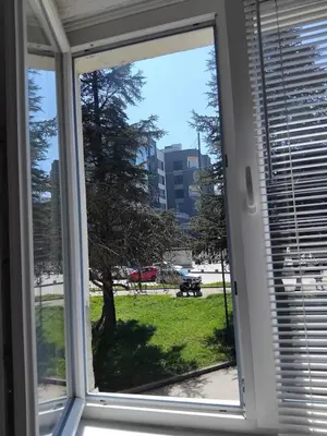 a window with a view of a park at AM Rooms in Visoko